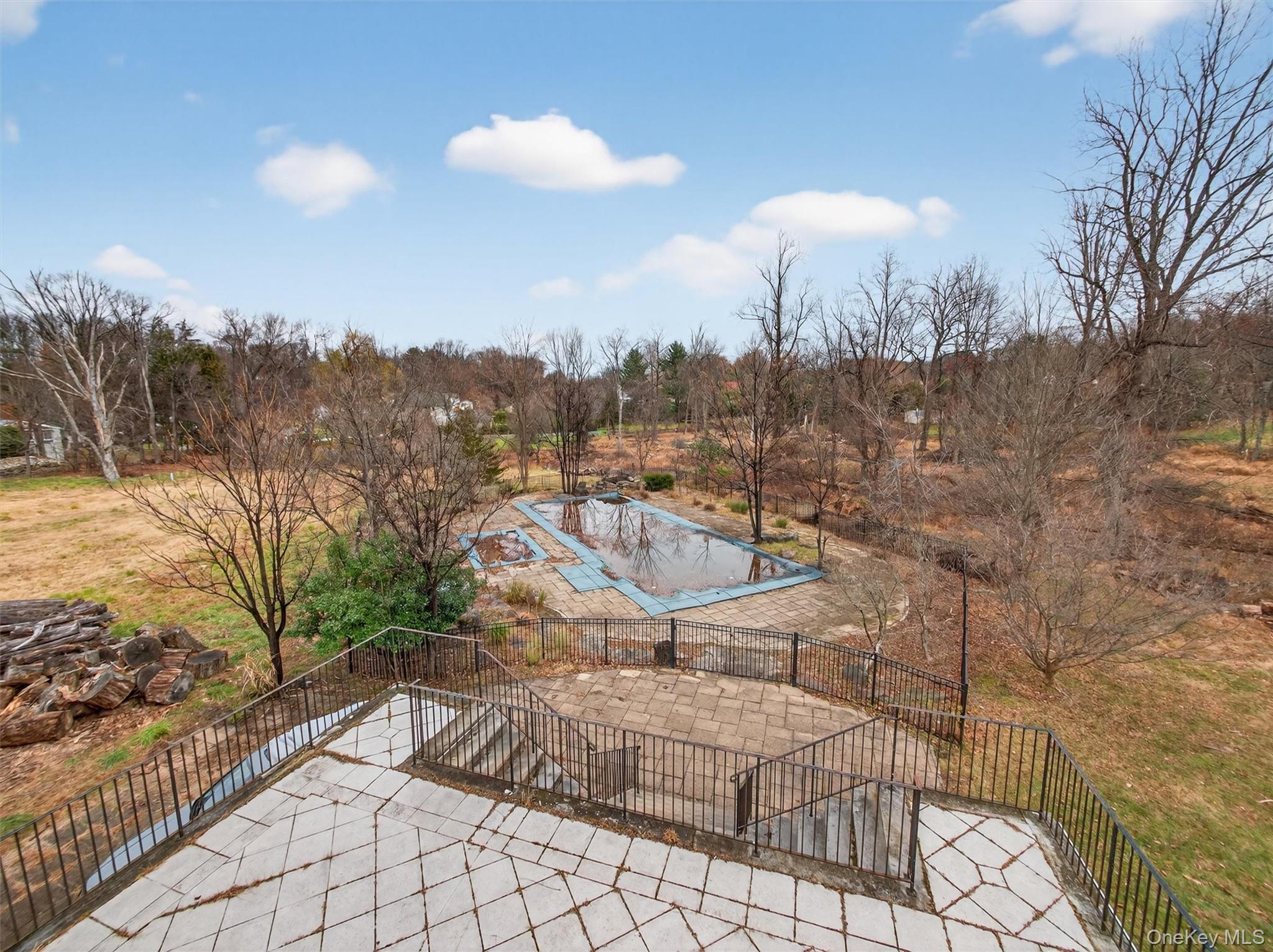 120 East Willow Tree Road Spring Valley, NY 10977 - Photo 22 of 49 View of swimming pool featuring a patio, a covered pool, and view of scattered trees