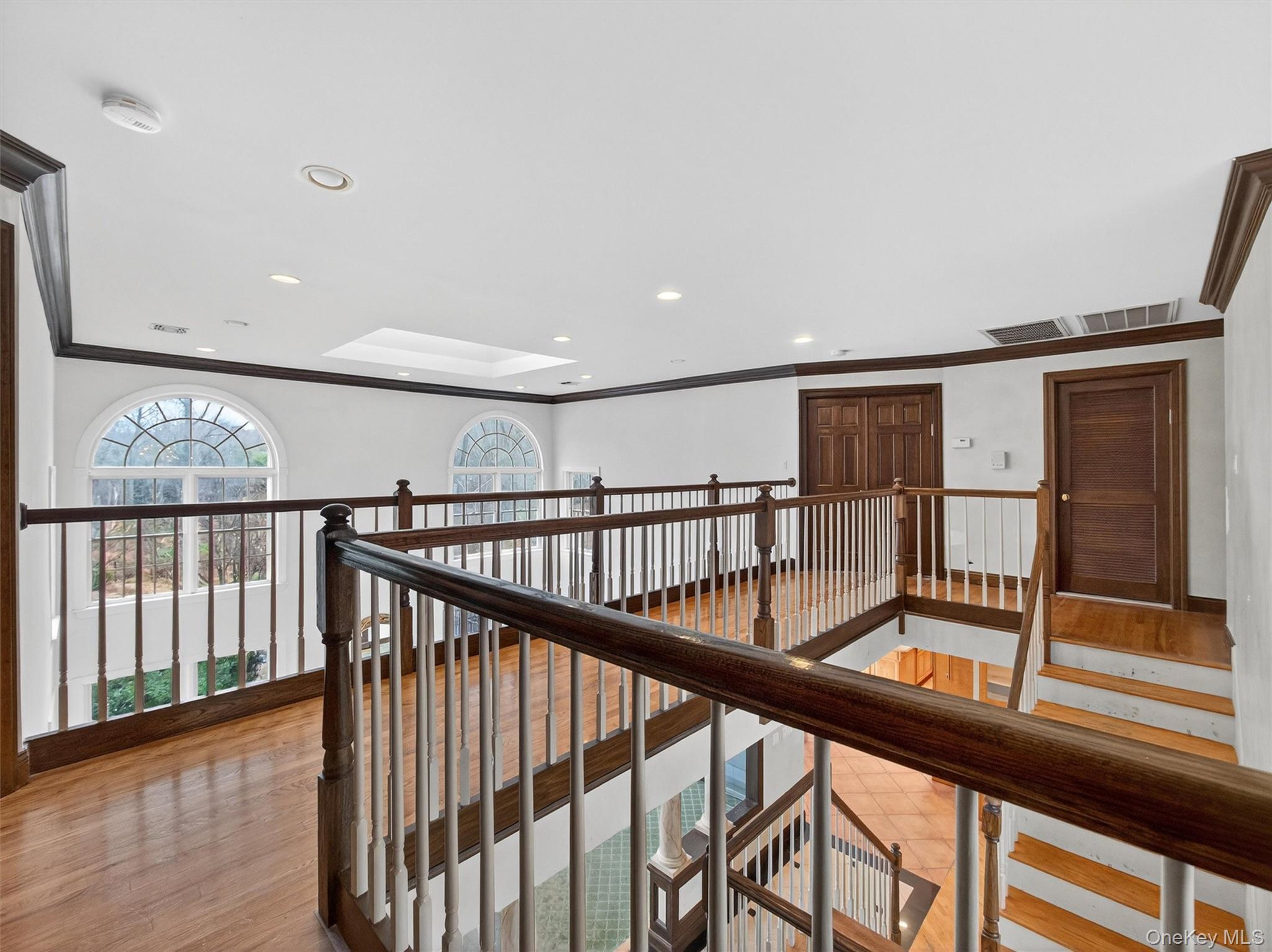 120 East Willow Tree Road Spring Valley, NY 10977 - Photo 29 of 49 Hallway featuring crown molding, recessed lighting, light wood-style floors, an upstairs landing, and a skylight