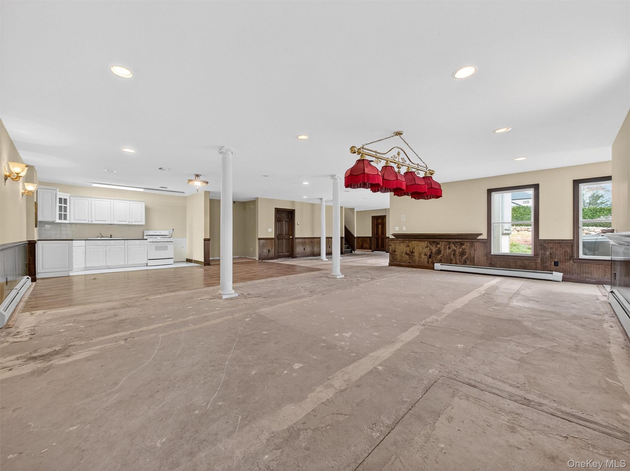 120 East Willow Tree Road Spring Valley, NY 10977 - Photo 31 of 49 Unfurnished living room with wainscoting, a baseboard heating unit, and recessed lighting