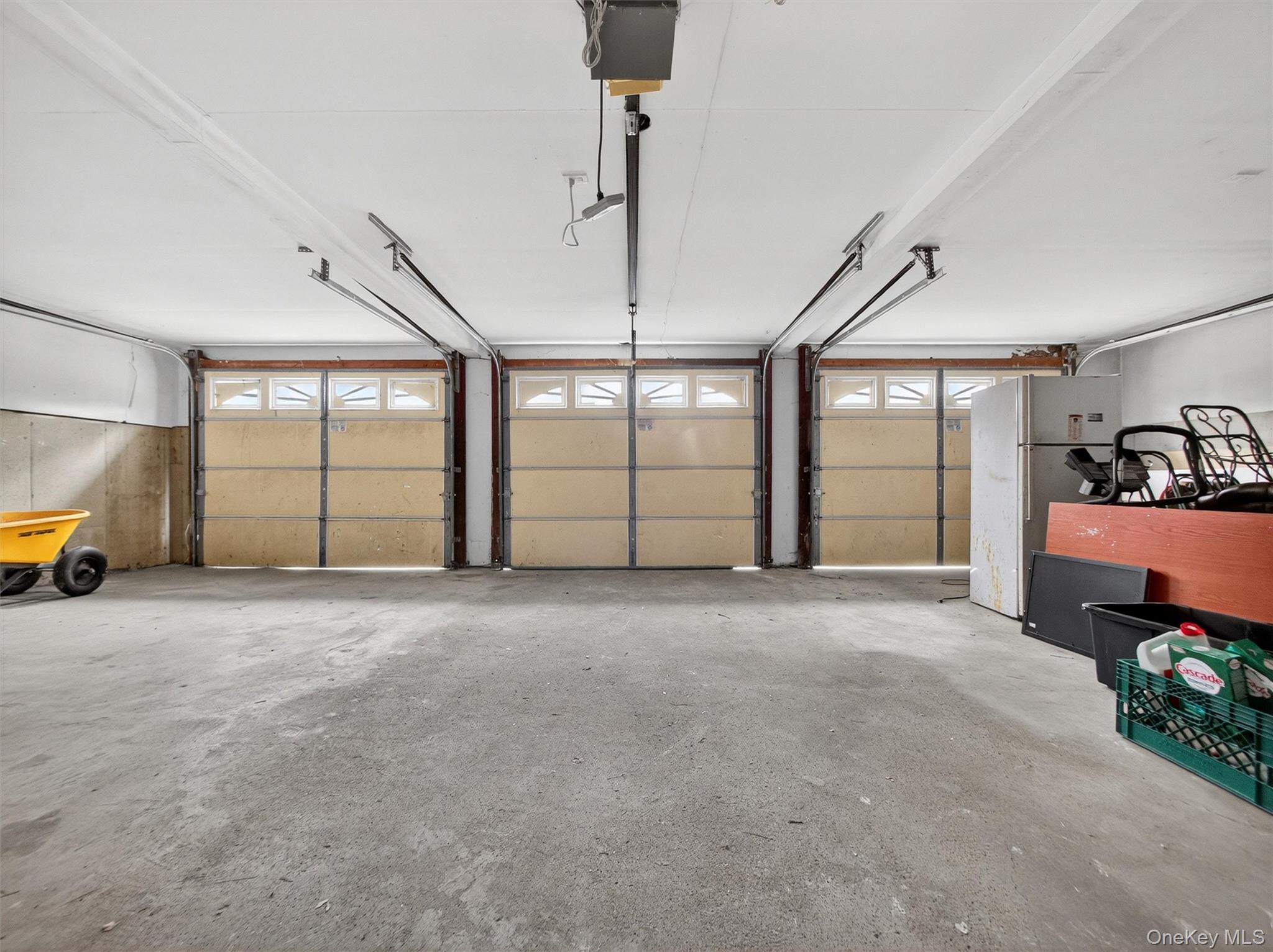 120 East Willow Tree Road Spring Valley, NY 10977 - Photo 38 of 49 Garage featuring freestanding refrigerator and a garage door opener