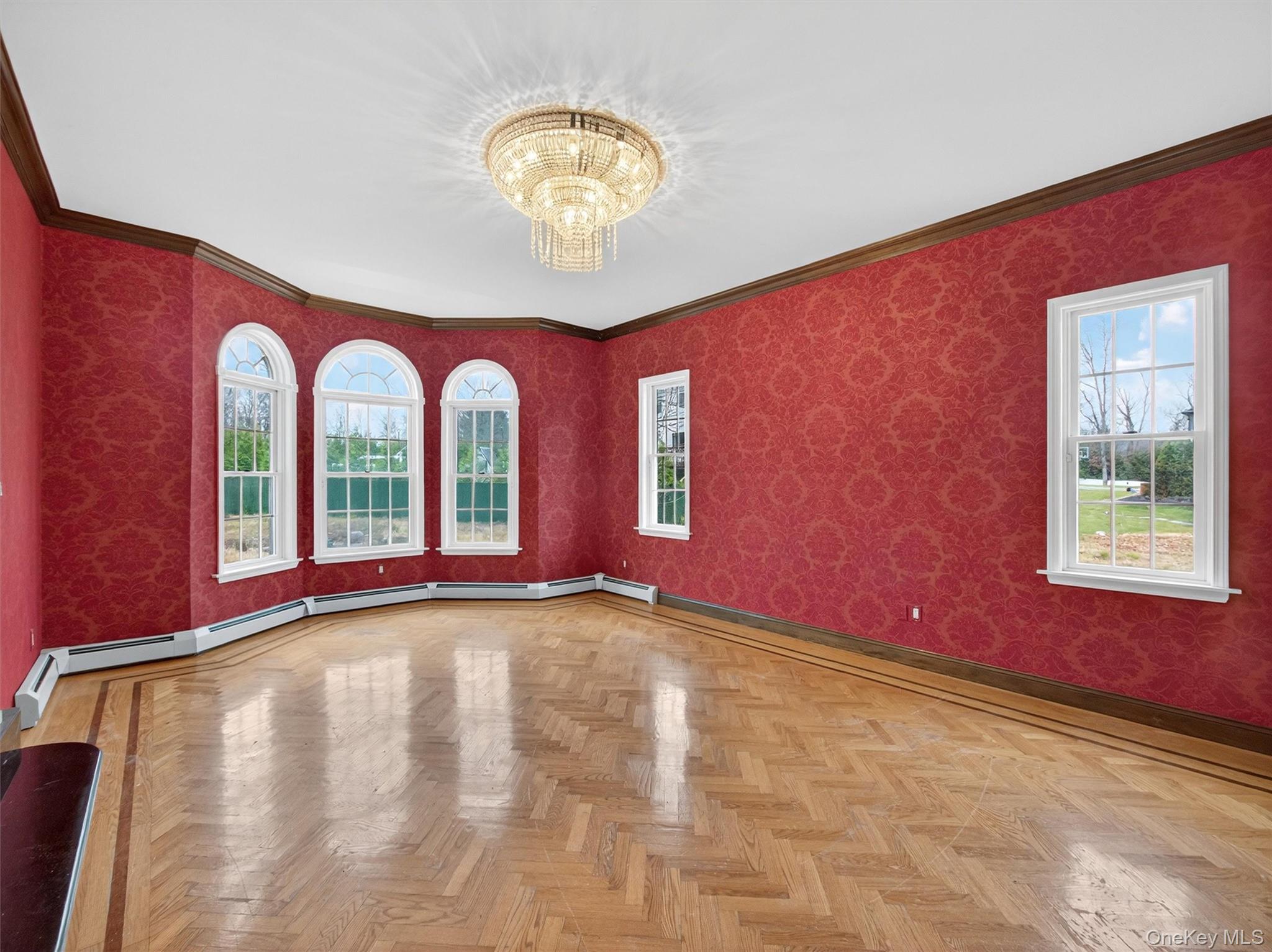 120 East Willow Tree Road Spring Valley, NY 10977 - Photo 6 of 49 Spare room featuring wallpapered walls, a chandelier, ornamental molding, and healthy amount of natural light