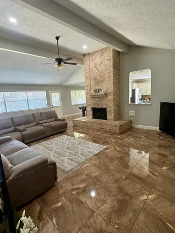 a living room with furniture and a fireplace