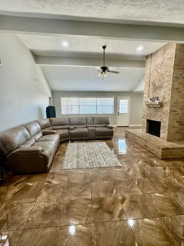 a living room with furniture and a chandelier