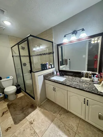 a view of a room with furniture and chandelier fan
