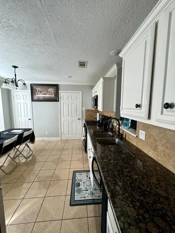a kitchen with a sink stove and cabinets