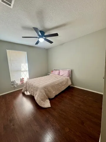 a bedroom with a bed and window