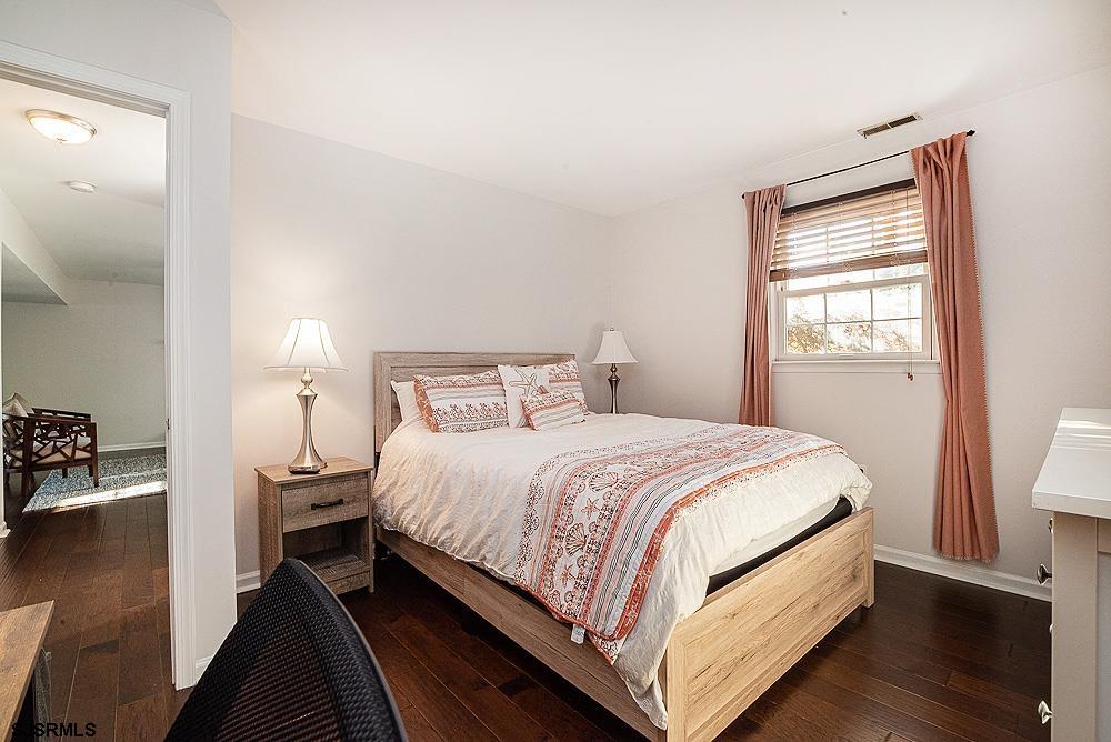 68 Defeo Lane Somers Point, NJ 08244 - Photo 21 of 44 a bedroom with a bed and wooden floor