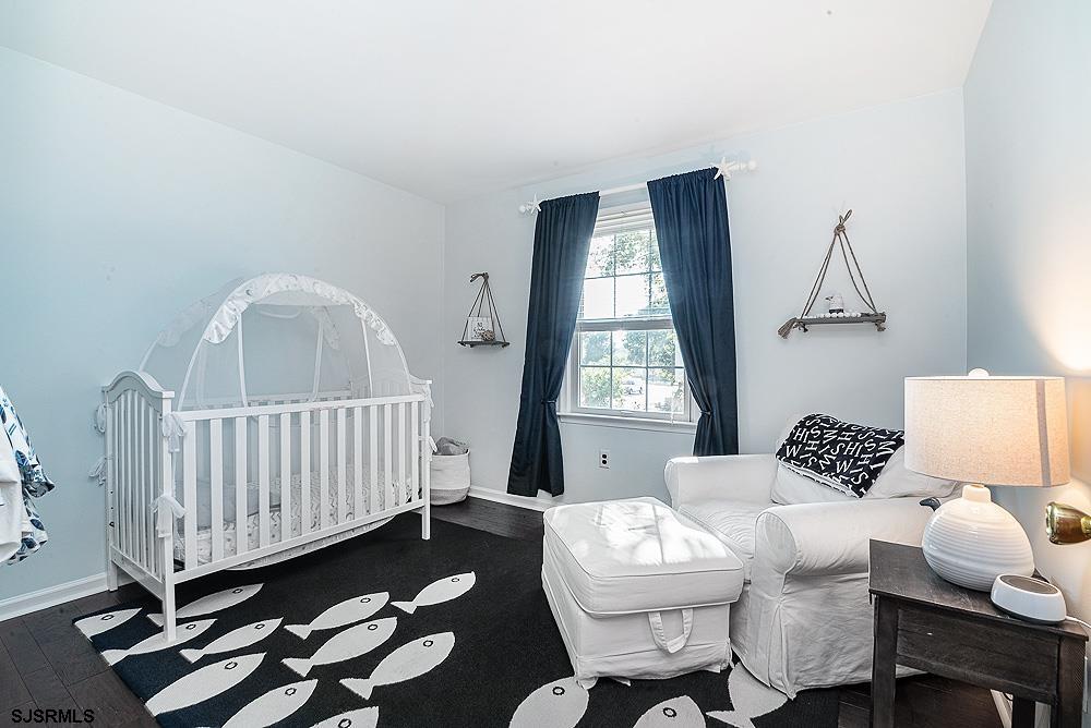 68 Defeo Lane Somers Point, NJ 08244 - Photo 26 of 44 a bedroom with a bed and wooden floor