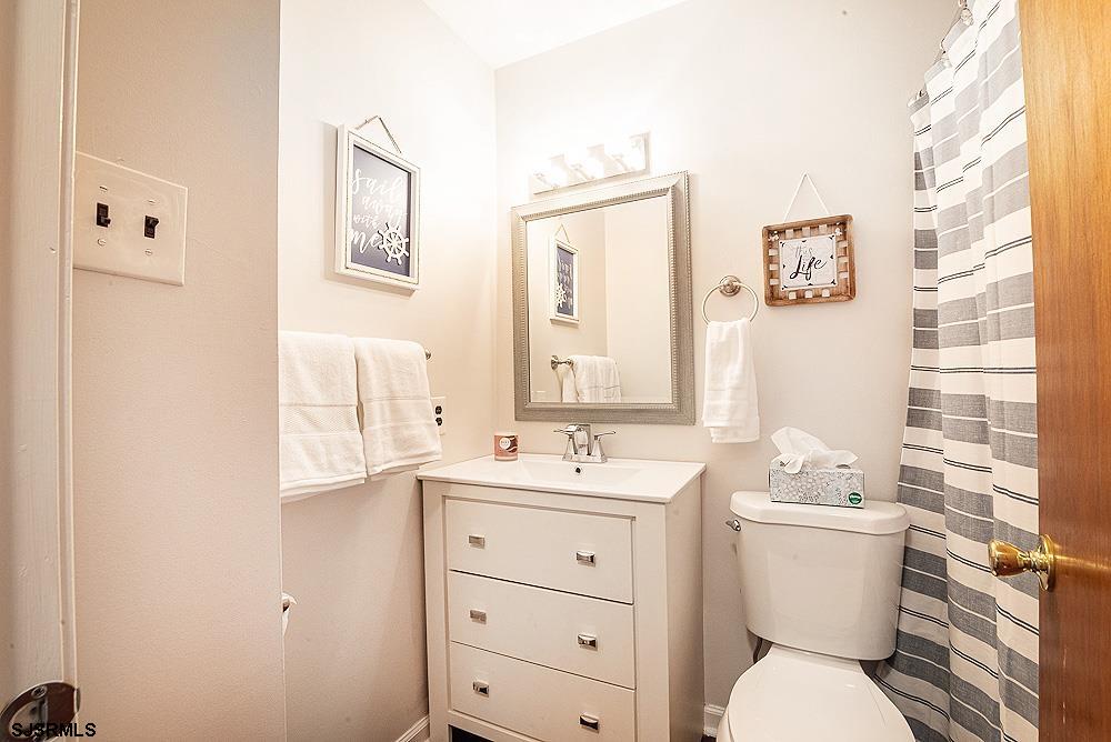 68 Defeo Lane Somers Point, NJ 08244 - Photo 27 of 44 a bathroom with a sink toilet vanity and mirror