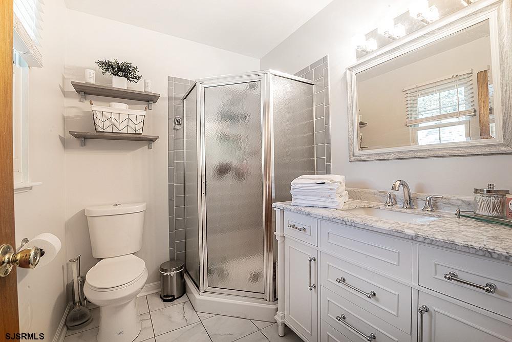 68 Defeo Lane Somers Point, NJ 08244 - Photo 28 of 44 a bathroom with a granite countertop toilet sink and shower