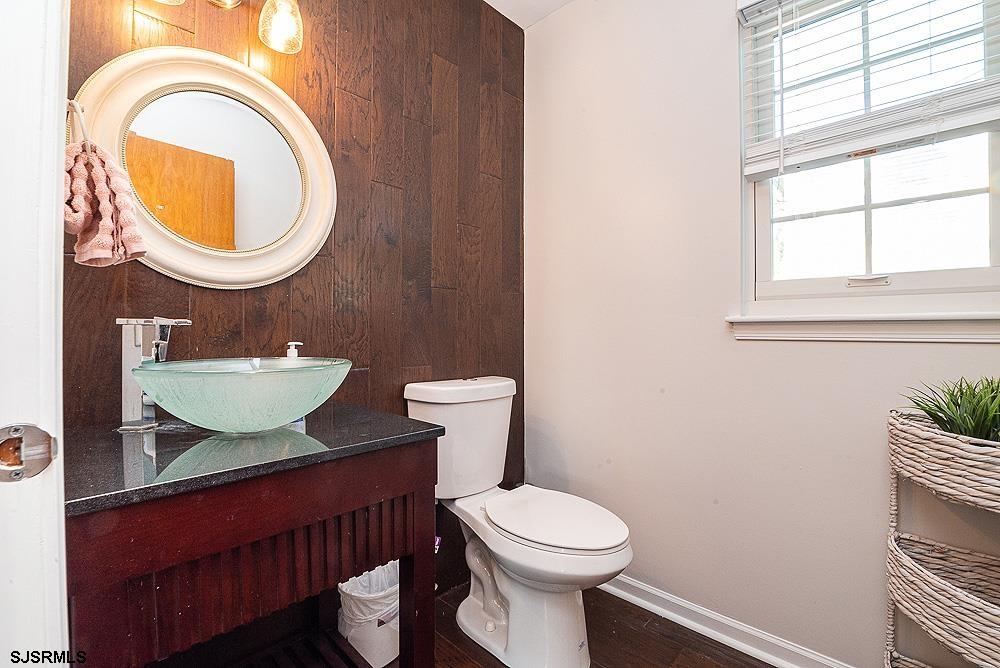 68 Defeo Lane Somers Point, NJ 08244 - Photo 30 of 44 a bathroom with a granite countertop toilet a sink and a mirror
