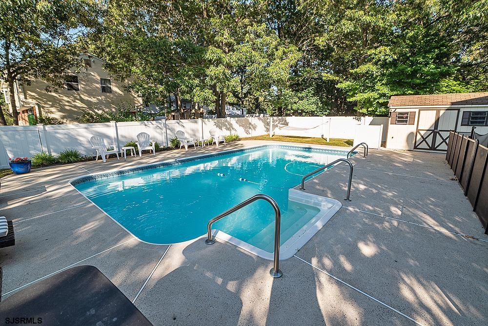 68 Defeo Lane Somers Point, NJ 08244 - Photo 34 of 44 a view of a swimming pool with a patio and garden