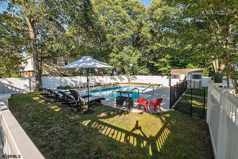 68 Defeo Lane Somers Point, NJ 08244 - Photo 38 of 44 an outdoor space with furniture and umbrella