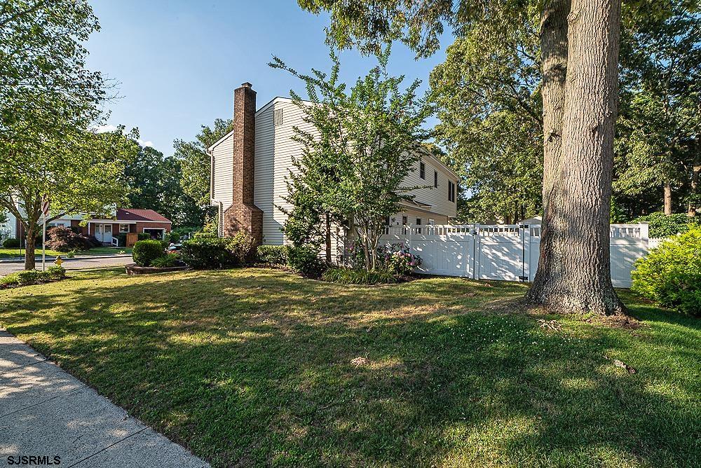 68 Defeo Lane Somers Point, NJ 08244 - Photo 39 of 44 a view of a tall building with a big yard and large trees