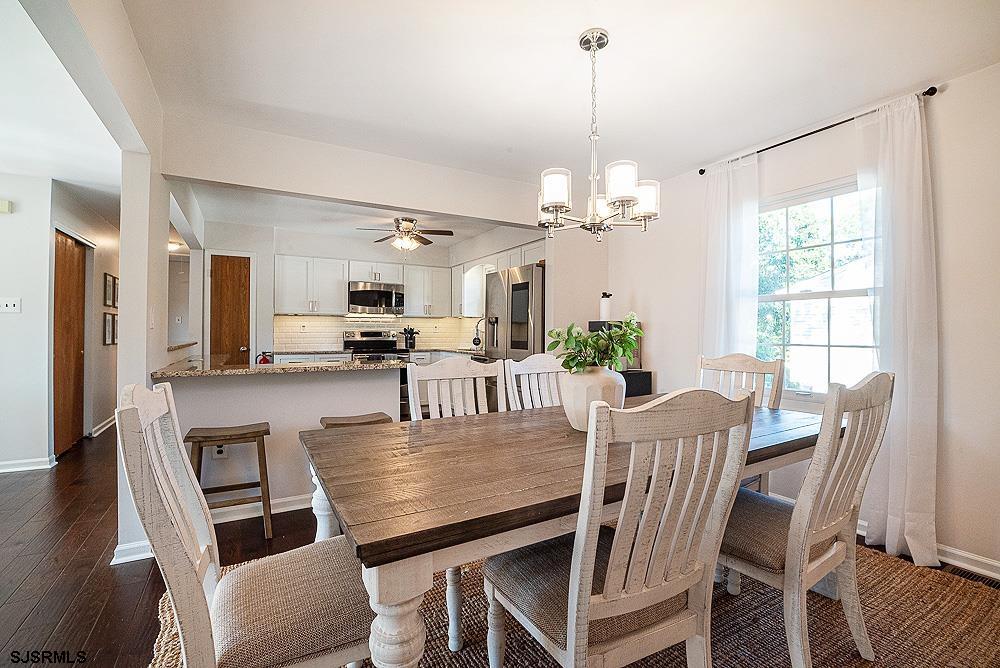 68 Defeo Lane Somers Point, NJ 08244 - Photo 9 of 44 a view of a dining room with furniture a chandelier and wooden floor