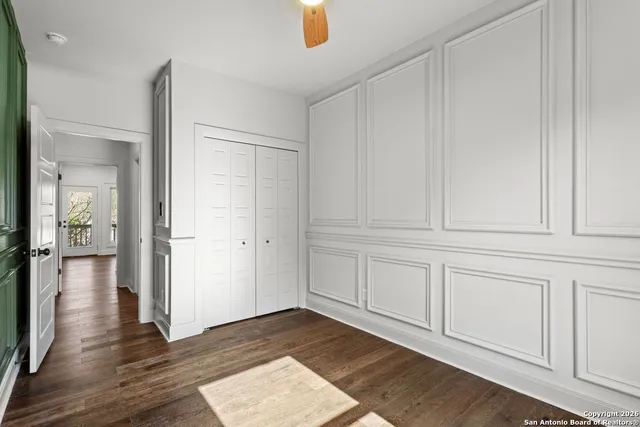 a view of empty room with wooden floor