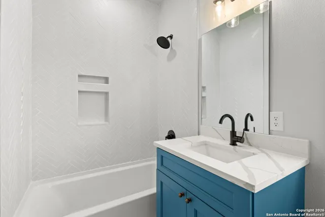 a bathroom with a sink and a mirror