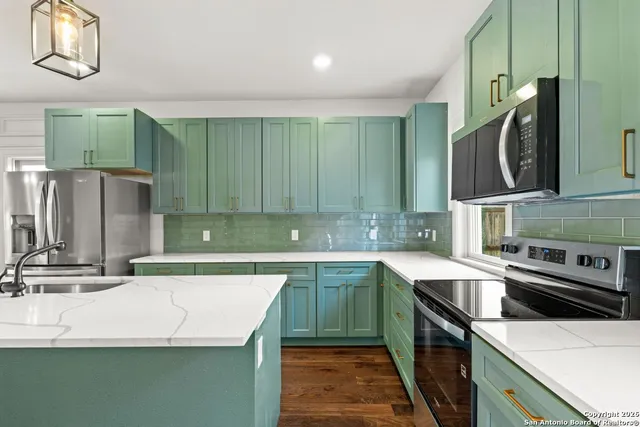 a kitchen that has a sink and a stove top oven