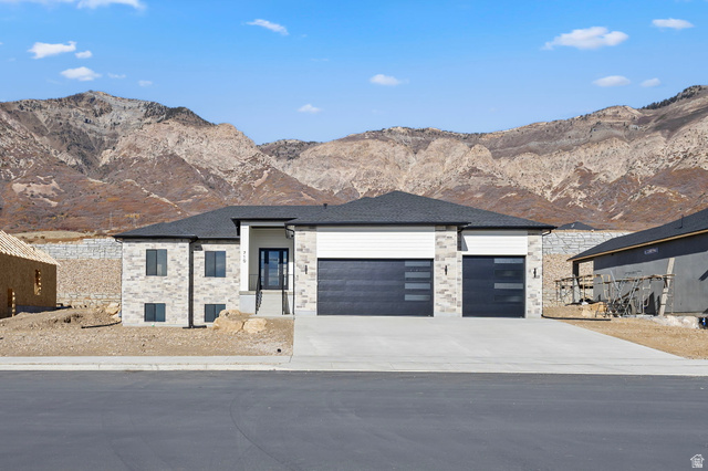 710 East Mountain Road North Ogden, UT 84414 - Photo 2 of 36 View of front of property with a mountain view, concrete driveway, a garage, and a shingled roof