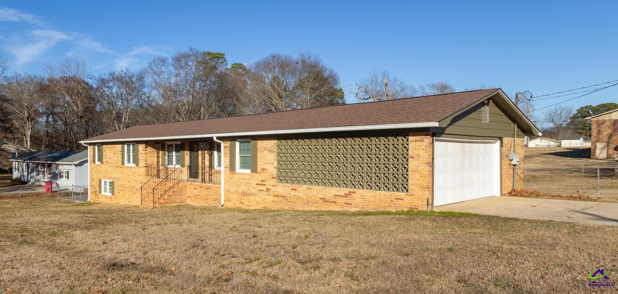 3491 Sandy Circle Macon, GA 31216 - Photo 2 of 47 a front view of a house with a yard and garage