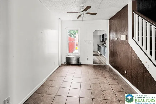 a kitchen with granite countertop a stove sink and cabinets