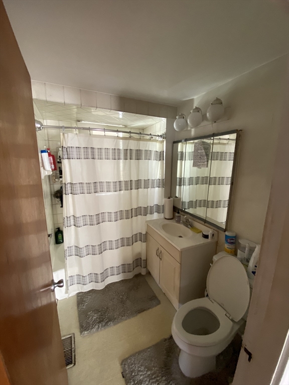 55 Cherry Street, Unit 55 Medford, MA 02155 - Photo 1 of 9 a bathroom with a granite countertop toilet sink and shower