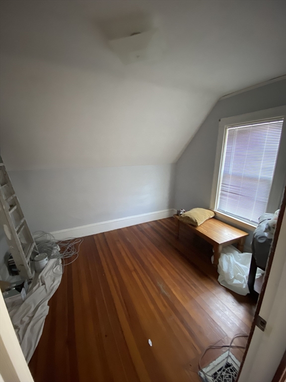 55 Cherry Street, Unit 55 Medford, MA 02155 - Photo 3 of 9 a bedroom with a bed and wooden floor