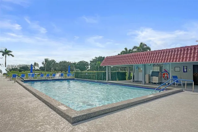 a view of a swimming pool with chair and tables
