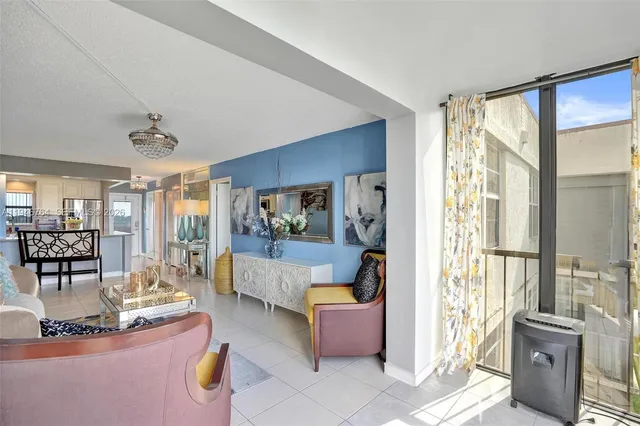 a living room with furniture and large windows