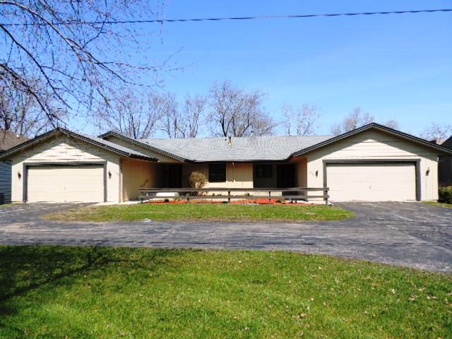 5642 Spring Brook Road Rockford, IL 61114 - Photo 1 of 25 a front view of a house with garden