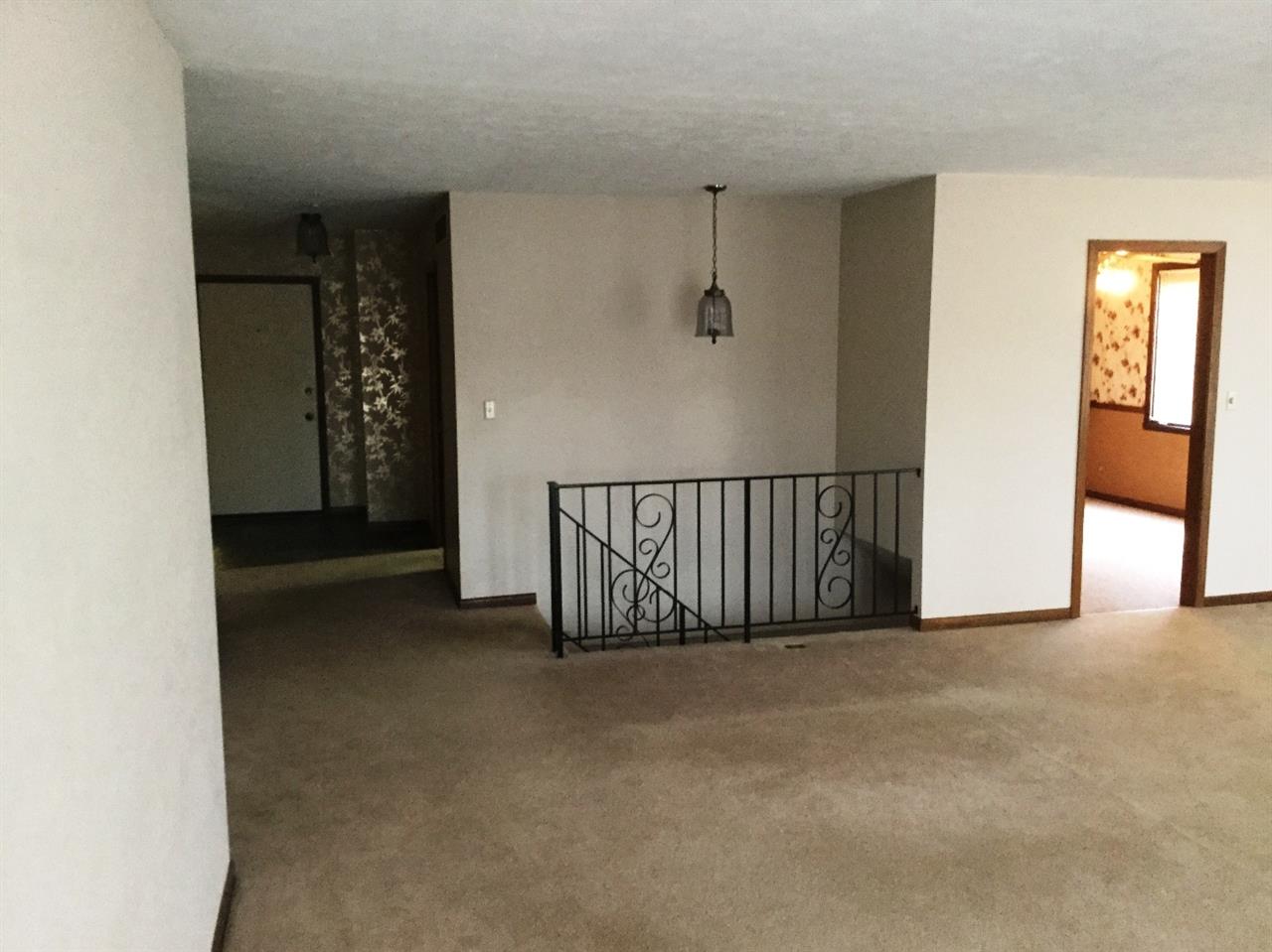 5642 Spring Brook Road Rockford, IL 61114 - Photo 12 of 25 a view of a hallway with wooden floor and windows
