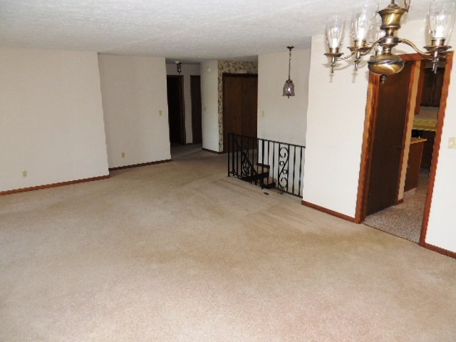 5642 Spring Brook Road Rockford, IL 61114 - Photo 23 of 25 a view of a hallway with a chandelier