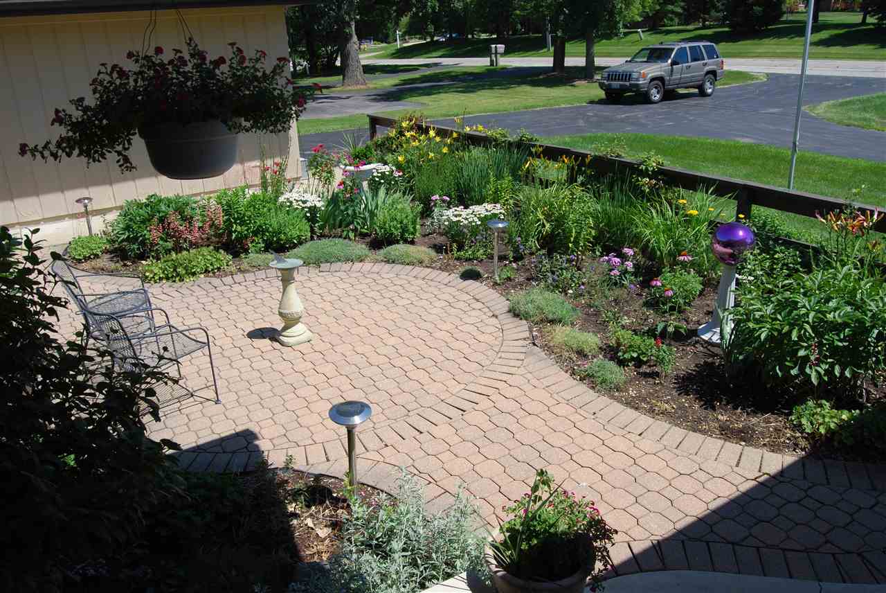 5642 Spring Brook Road Rockford, IL 61114 - Photo 6 of 25 a view of a park with plants and a bench