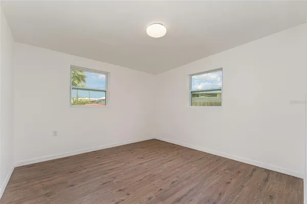 a view of a room with wooden floor and window