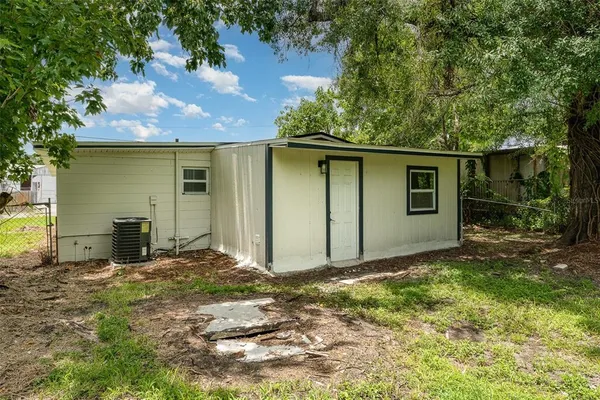 a view of backyard of house with green space