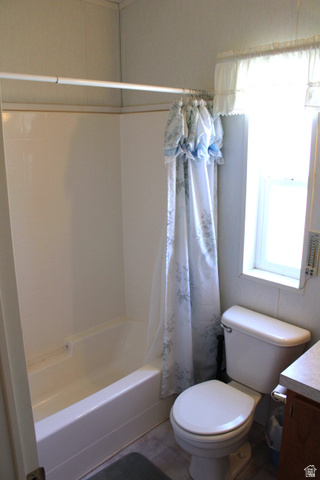 22580 Spring Creek Drive, Unit B61 Fairview, UT 84629 - Photo 32 of 39 Bathroom featuring a standard bathtub with an integrated shower, a white toilet, and a window providing natural light