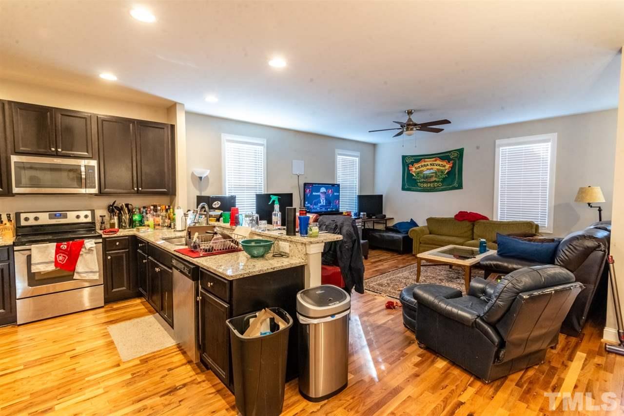 918 Chaney Road Raleigh, NC 27606 - Photo 2 of 4 a living room with stainless steel appliances kitchen island granite countertop a stove and a sink
