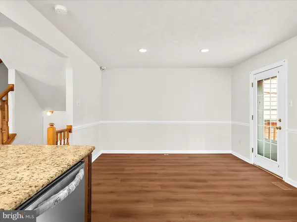 a view of kitchen and empty room