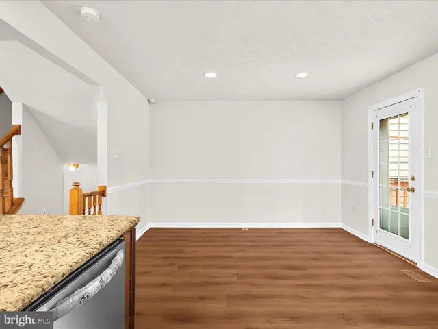 a view of kitchen and empty room