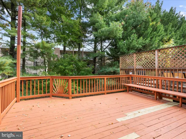 a view of balcony with wooden floor and fence