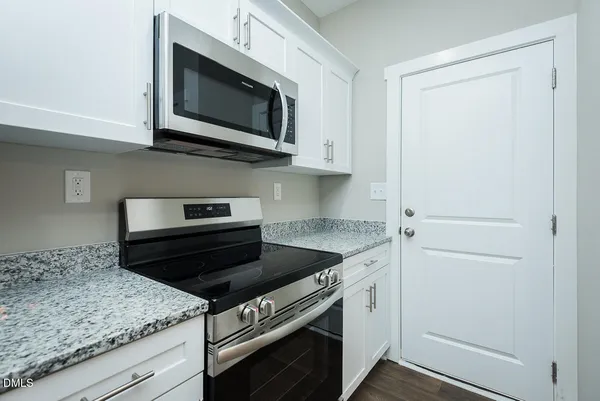 a kitchen with a stove microwave and sink