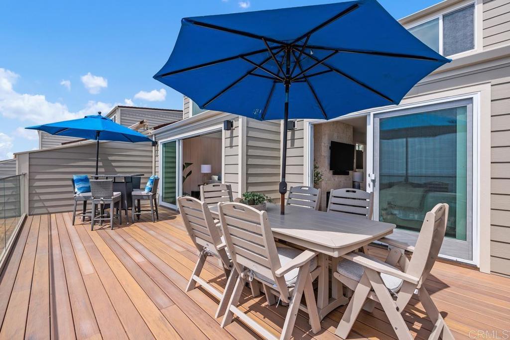 1856 Parliament Road Encinitas, CA 92024 - Photo 19 of 42 a view of a patio with a table and chairs under an umbrella