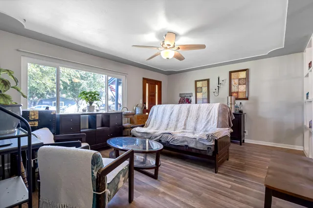 a bedroom with a bed window and a table