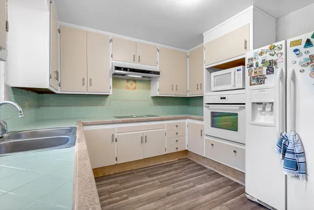 a kitchen with cabinets appliances and a sink