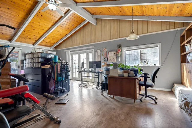 a living room with furniture gym equipment and a rug