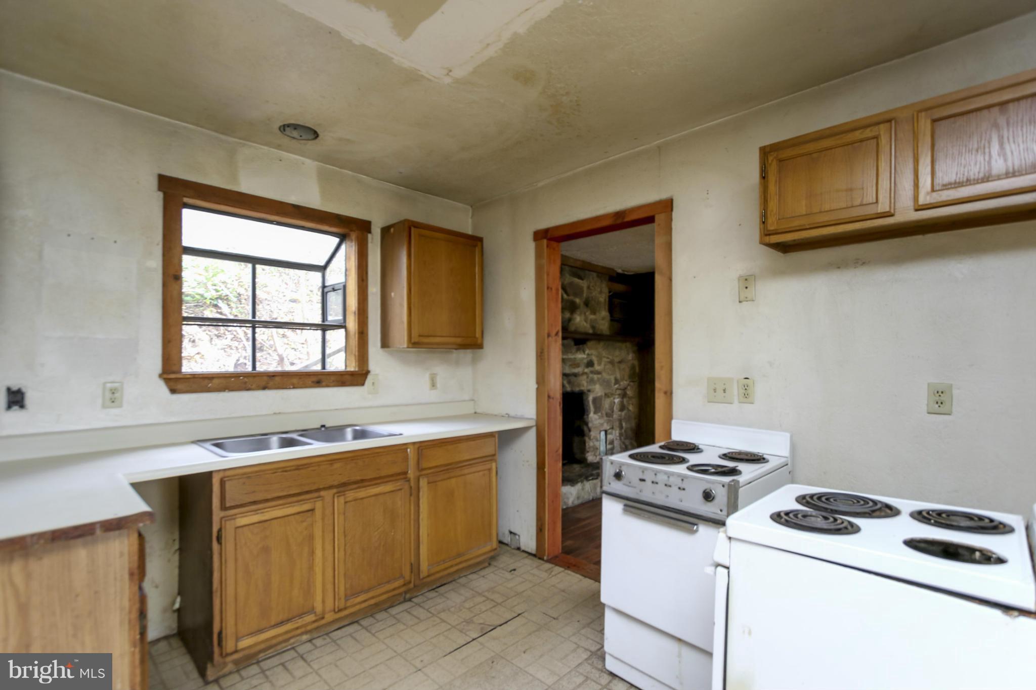 4516 Baptist Road Taneytown, MD 21787 - Photo 3 of 15 a kitchen with stainless steel appliances a stove a sink and a microwave