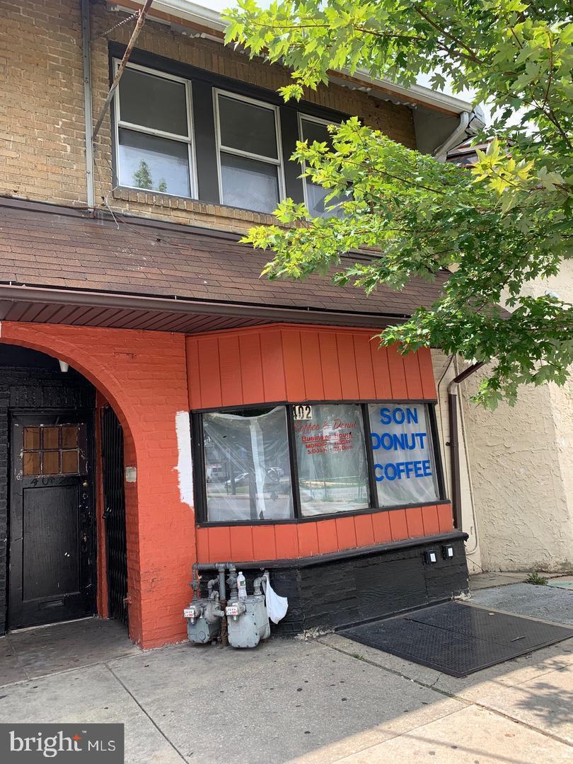 402 Long Lane Upper Darby, PA 19082 - Photo 1 of 7 a wooden bench sitting in front of a building