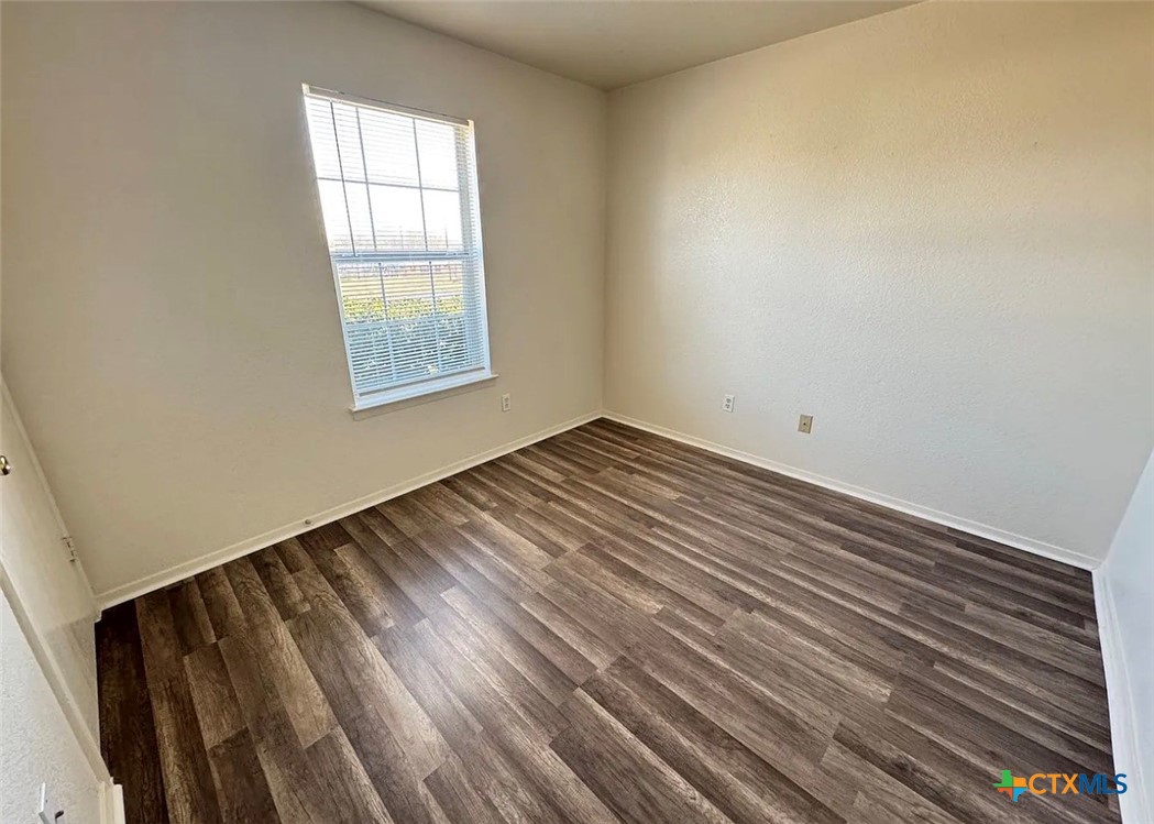 3404 Zephyr Road Killeen, TX 76543 - Photo 2 of 10 wooden floor in an empty room with a window