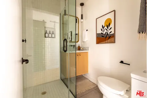 a bathroom with a shower and a toilet