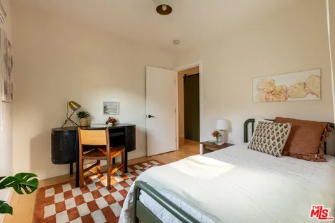a bedroom with a bed and a table in it